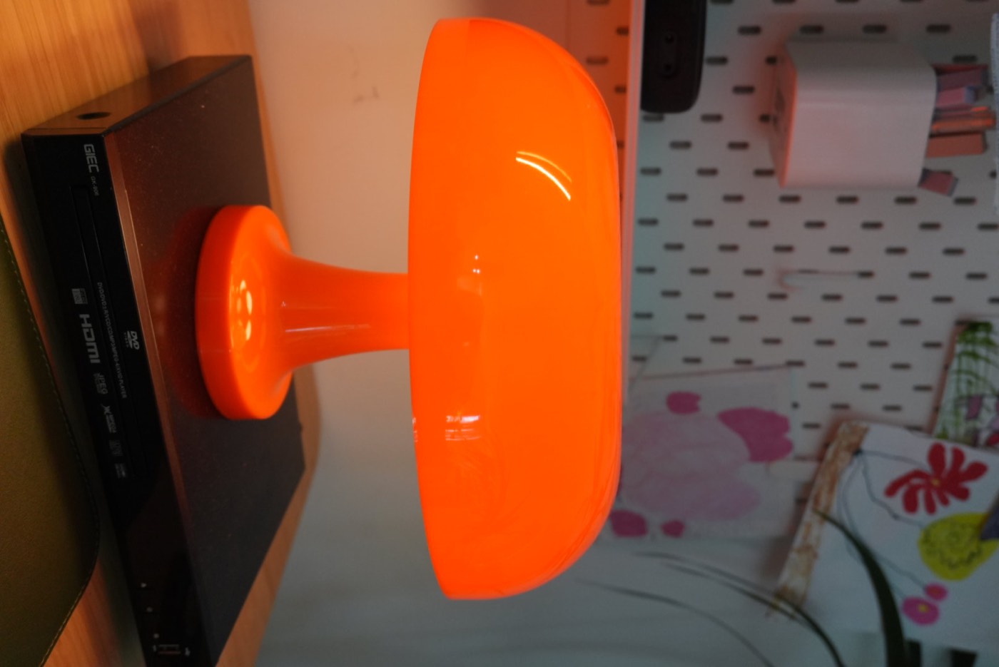 Close-up of the orange mushroom lamp on the desk