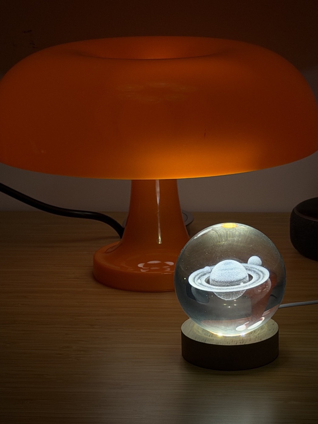 Glowing Saturn crystal lamp beside the orange mushroom lamp
